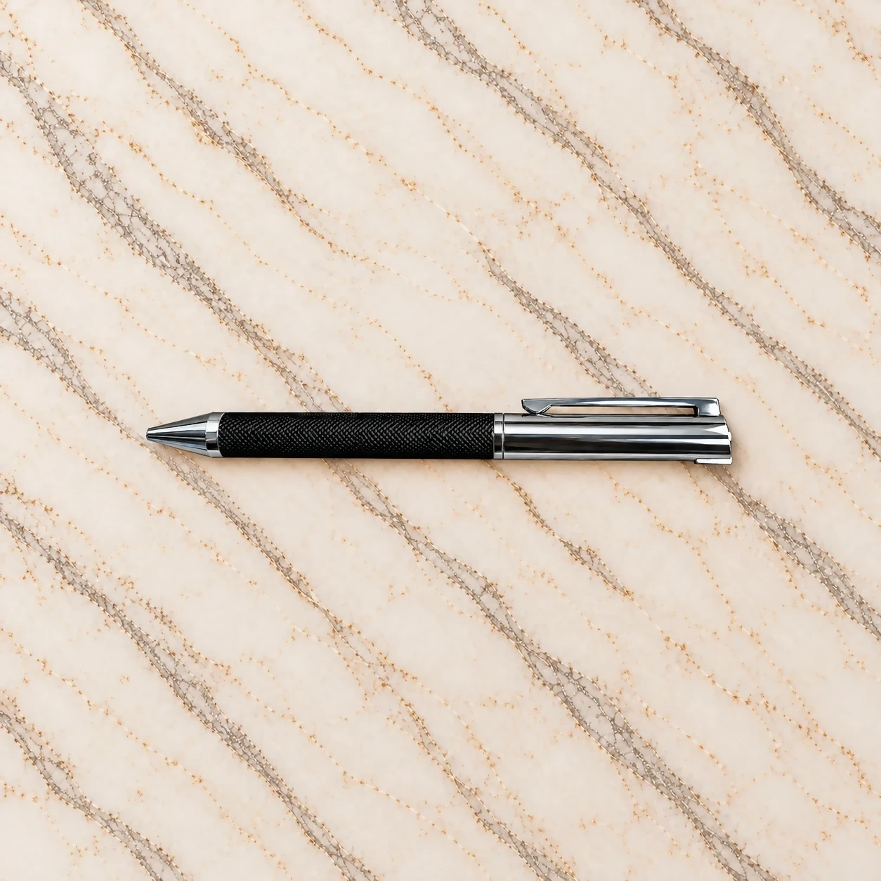 Executive metal pen with black textured grip and brushed steel cap